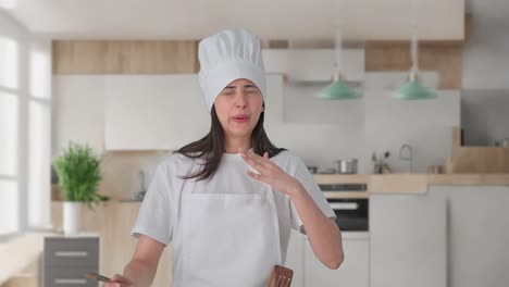 indian female professional chef tasting spicy food