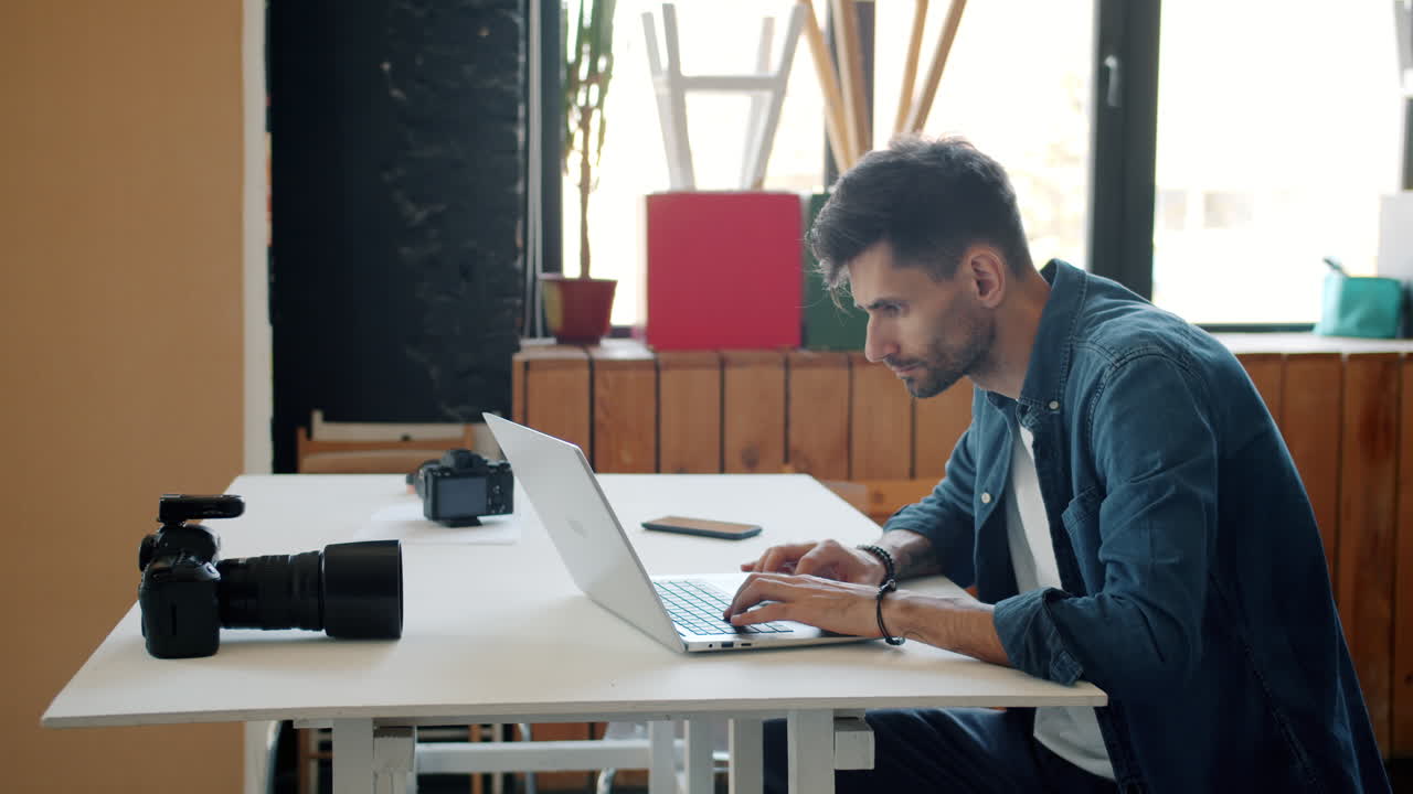 Photographer working on laptop in studio