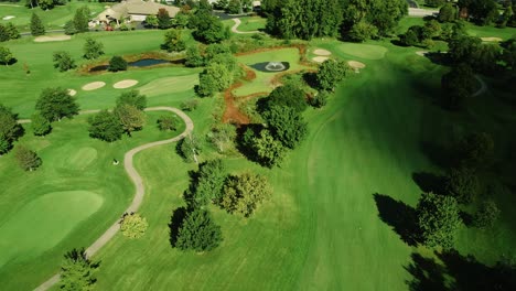 Aerial-Shot-Of-Dark-Shade-Coming-Over-Green-Golf-Field,-Northbrook-,-Illinois,-Chicago