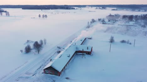 Schöne-Winter-Schneebedeckte-Landschaft-Bauernhaus-Scheune-Luftbild-über-Idyllische-Ländliche-Szene