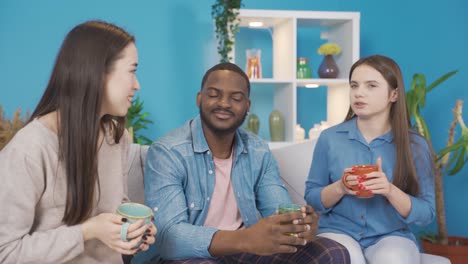 young people of different races chatting at home. they are friendly and happy.