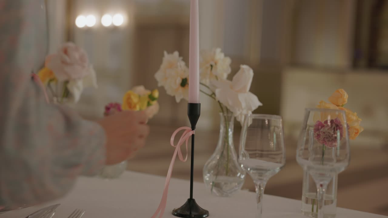 A Woman Organizer Placing Candles Over A Wedding Table Reception. Selective Focus Shot
