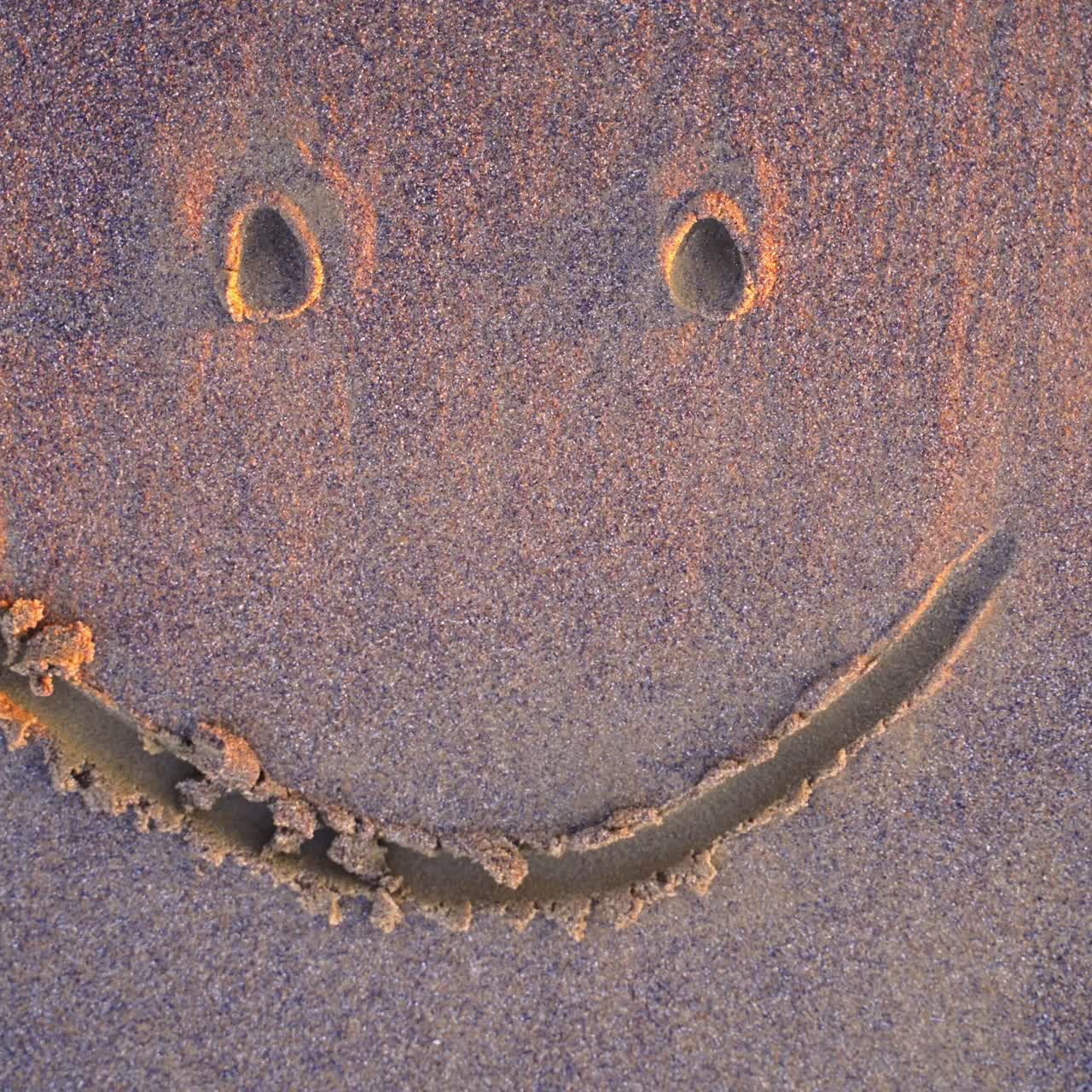 Smile face on sand