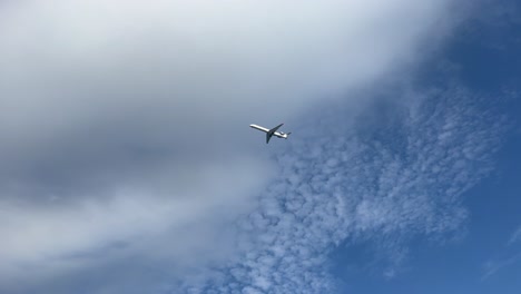 White-middle-size-jet-shot-from-the-ground-approaching-to-the-airport-of-Menorca,-Spain