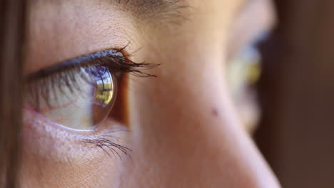 closeup of woman's face and big eyes looking away