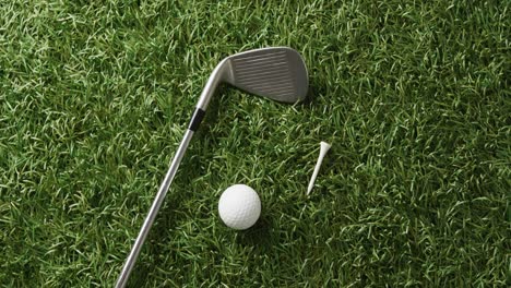 close up of golf club and ball on grass, copy space, slow motion