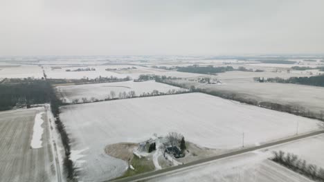 Timelapse-Above-Rural-Farmland-in-USA-on-Winter-Day-with-Snow