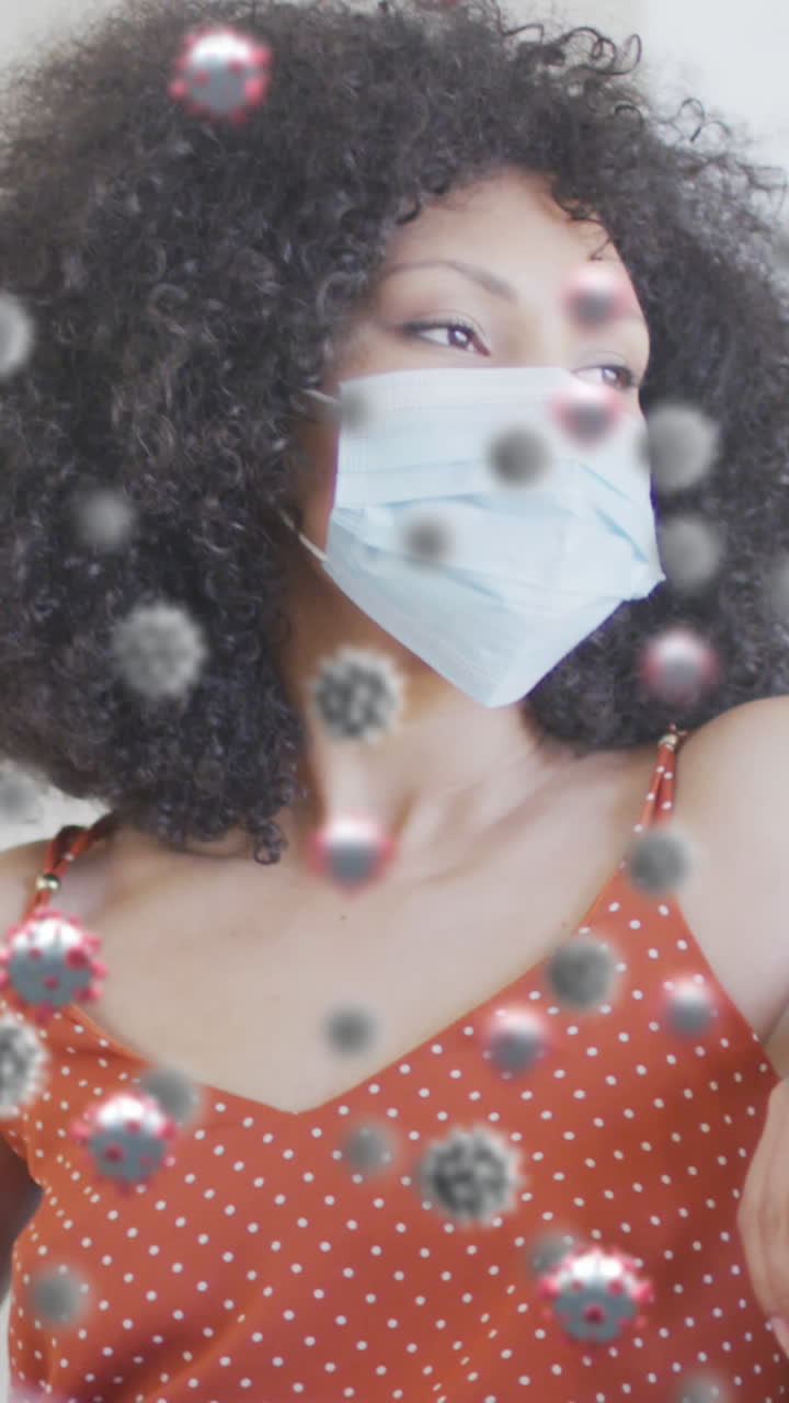 animación de células de virus sobre mujer afroamericana con máscara facial