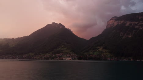 Aerial-view-of-the-city-of-Merligen-at-the-shore-of-Lake-Thun-during-sunset