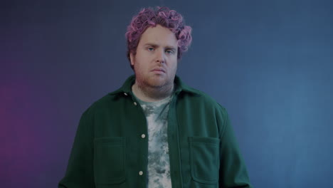 man with pink hair in green jacket