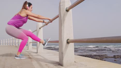 caucasian woman stretching on the docks