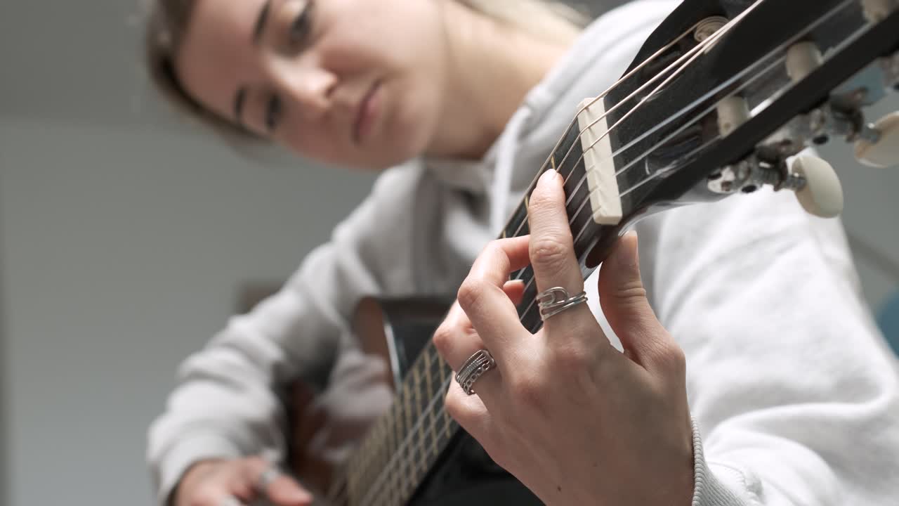 Captivating montage of a woman skillfully playing acoustic guitar