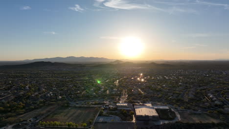 wide drone shot of the sun setting over one of arizona's many retirement-focused neighborhoods.
