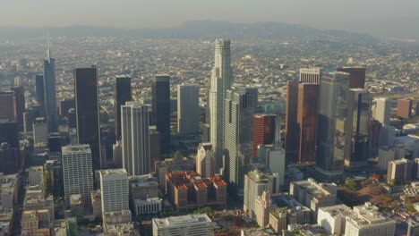 AERIAL:-Breathtaking-wide-shot-of-Downtown-Los-Angeles,-California-Skyline-in-beautiful-sunlight,blue-sky,