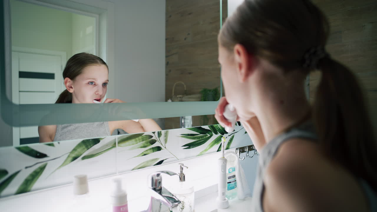 Girl Brushing Teeth and Washing Face