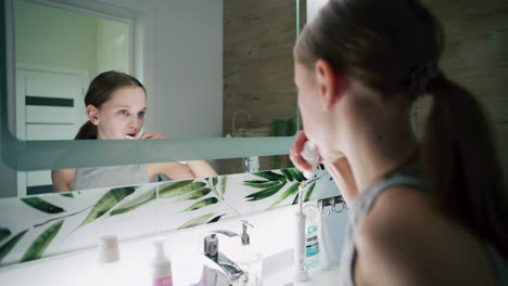 girl brushing teeth and washing face