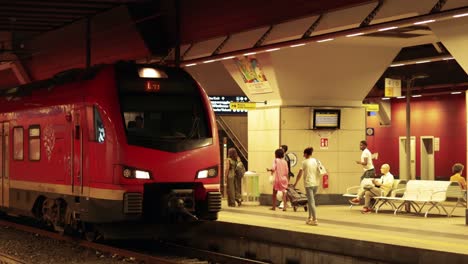 red train at night station