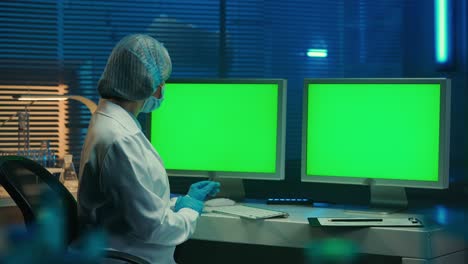 scientist working on computers in a laboratory environment