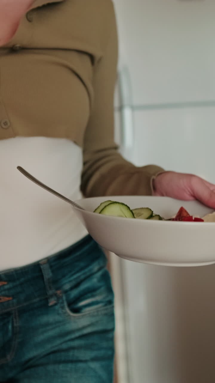 Woman Eating Healthy Breakfast in Kitchen. Focus on the plate