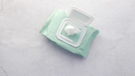 hand taking wet wipes from pack