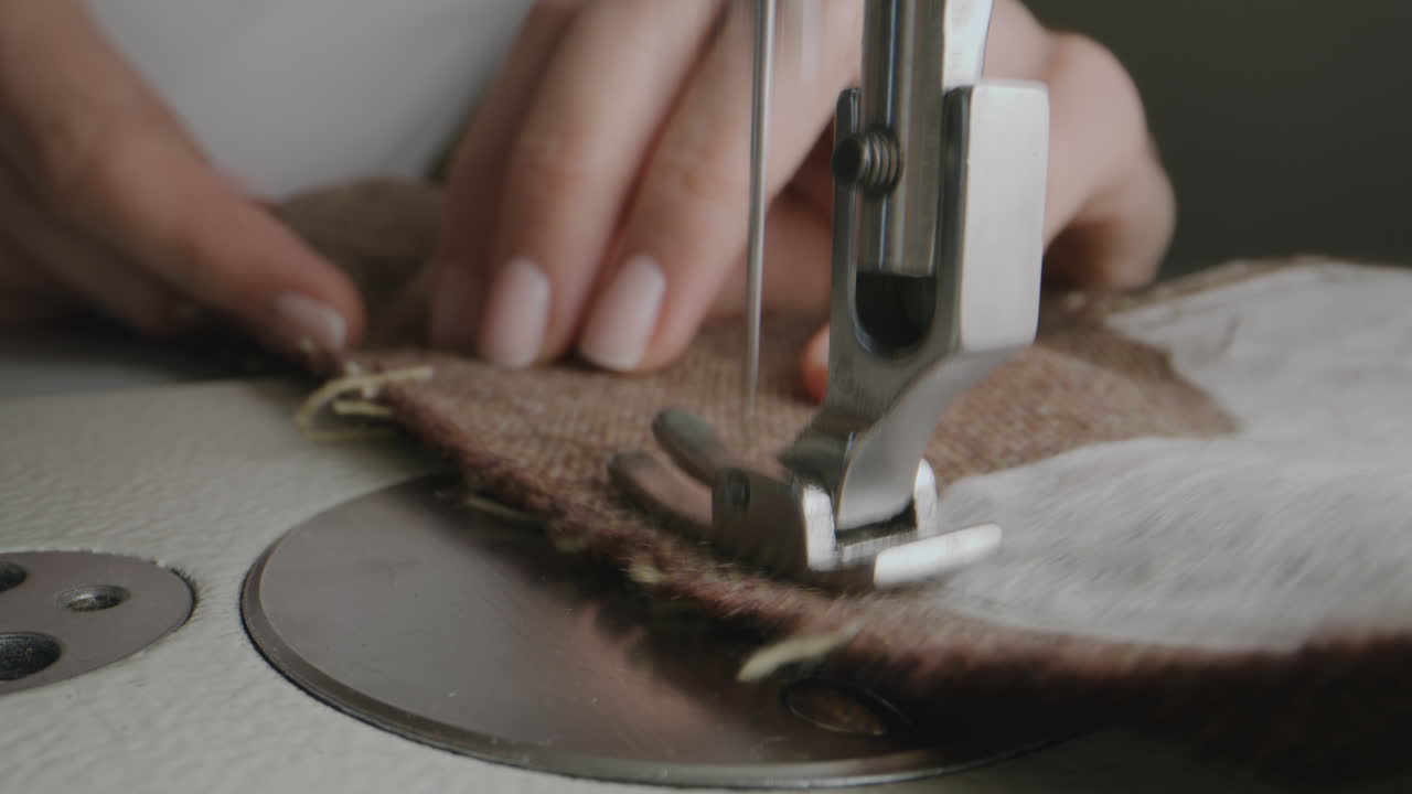 Woman sewing on a vintage sewing machine