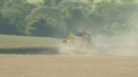 general shot of a seeder tractor harvesting soybeans in the field from a rear angle-1