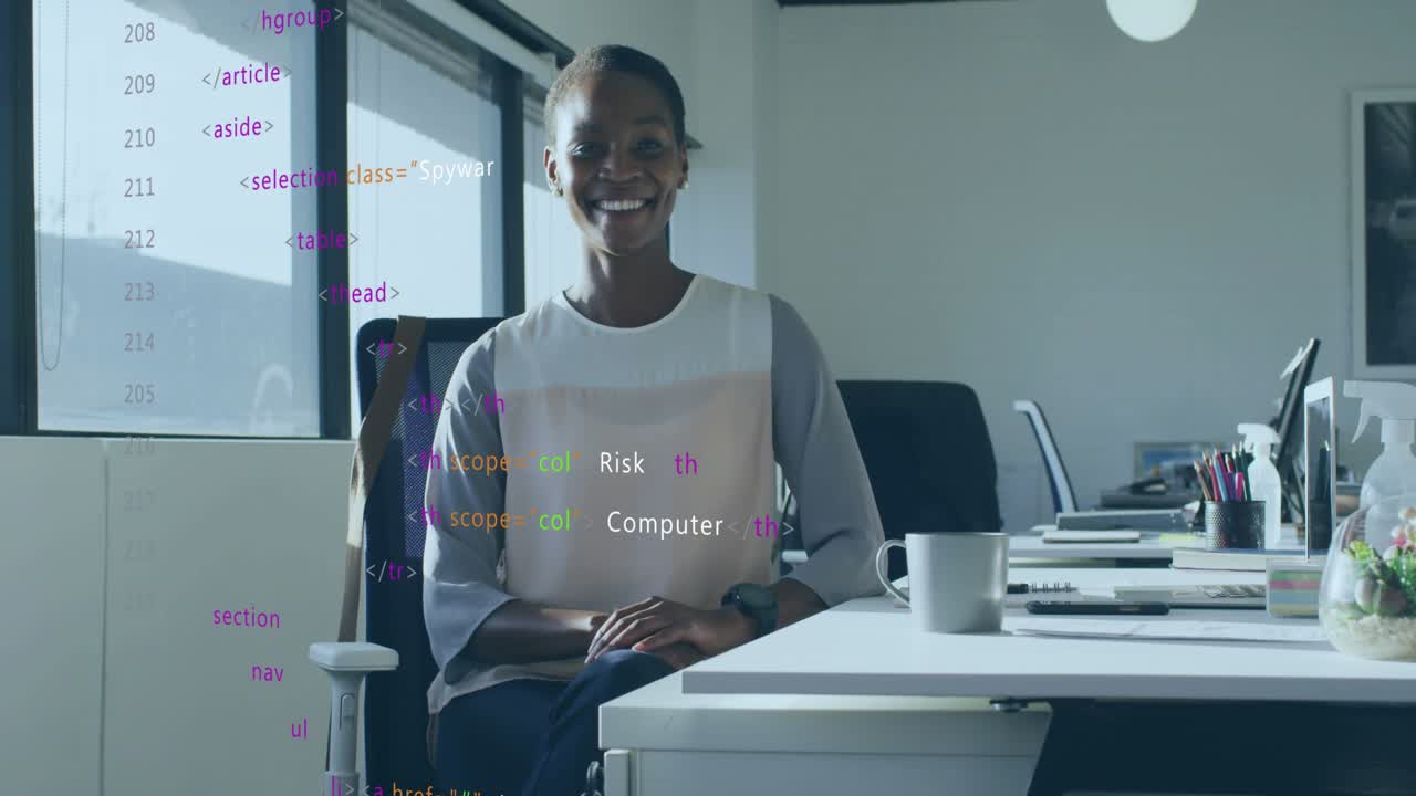 Professional woman sitting at desk smiling initiating code overlay and evolving cybersecurity terms