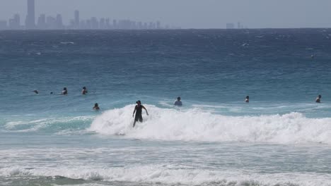 multiple surfers catching waves on a clear day