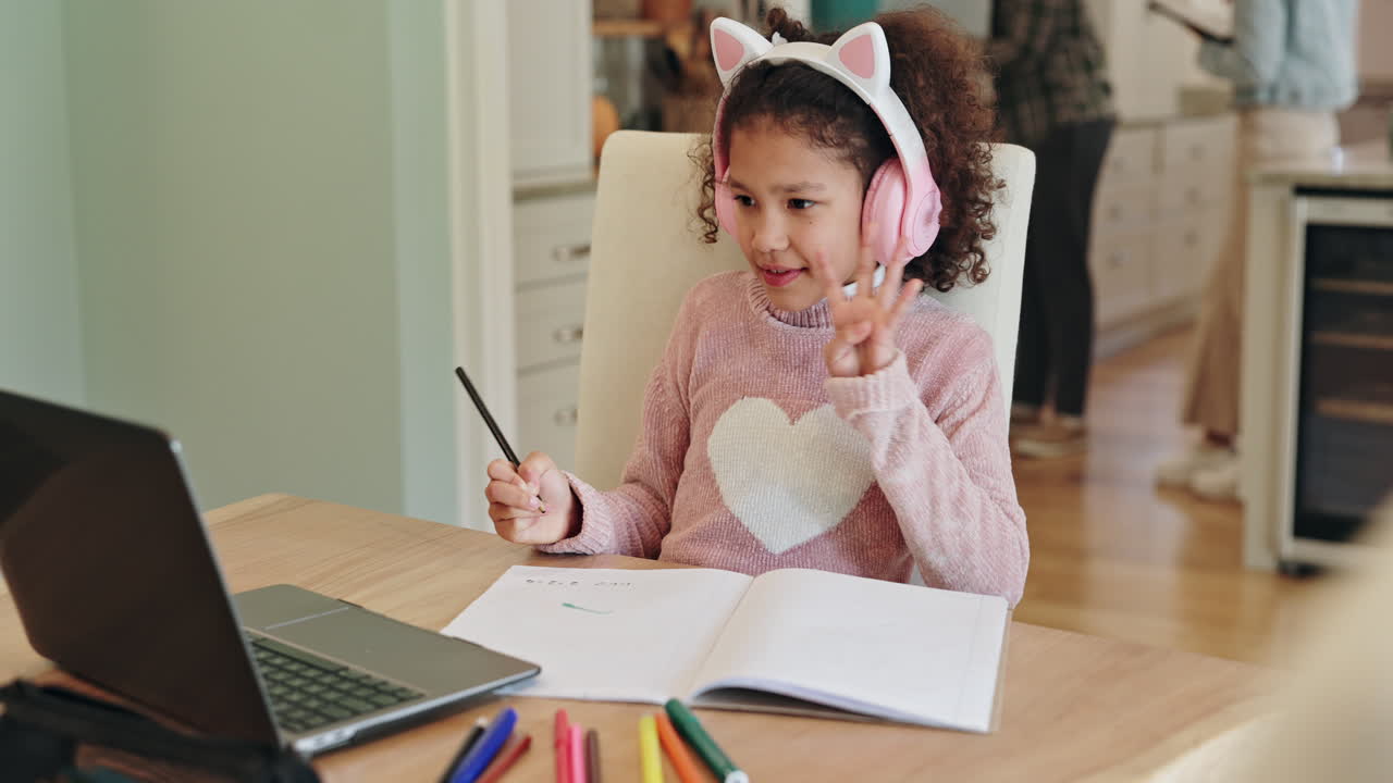 Child doing homework with laptop and headphones