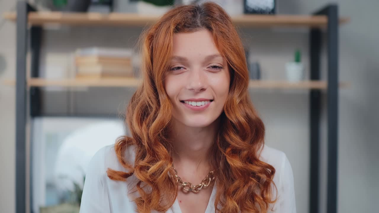 Young caucasian woman looking at camera cutely blinking and smiling