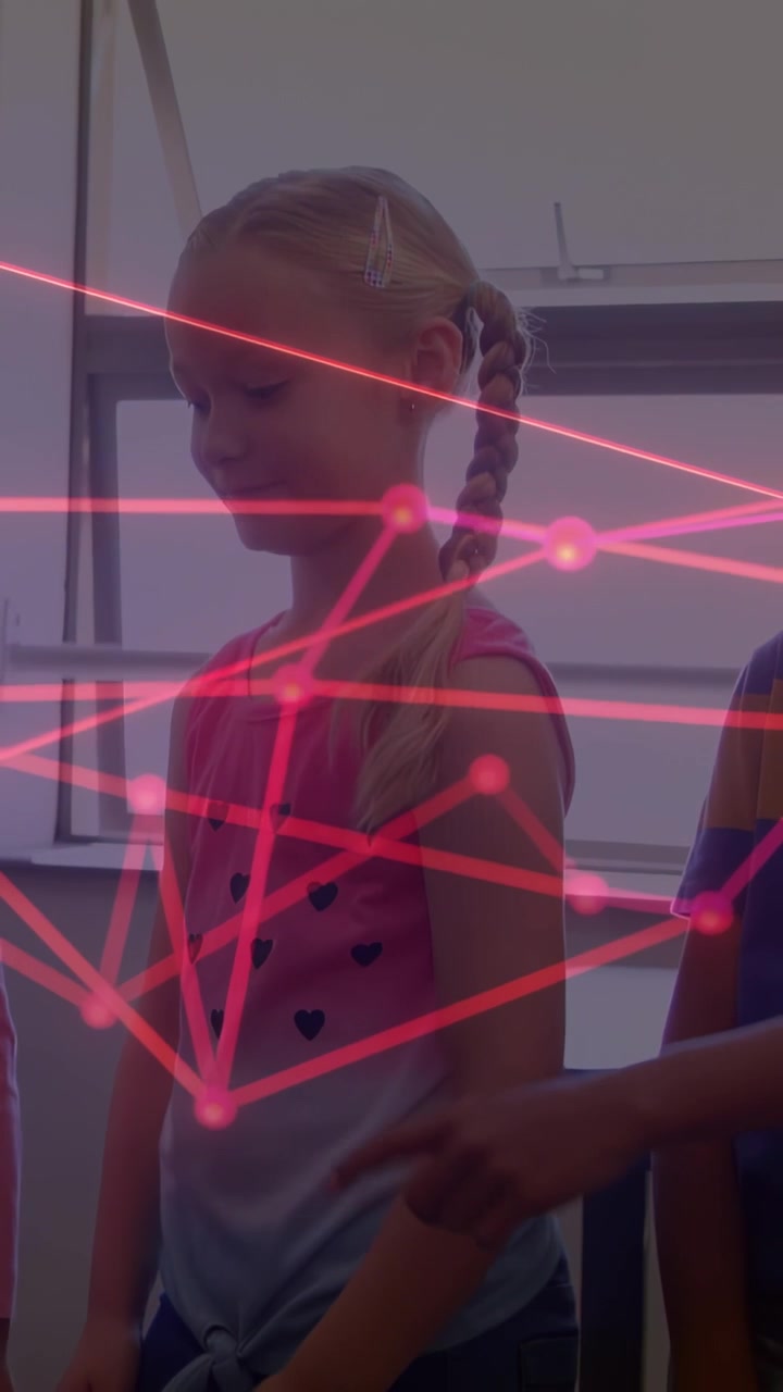 Vertical video: Magenta net appearing in classroom girl observing as boy touching arm testing nodes