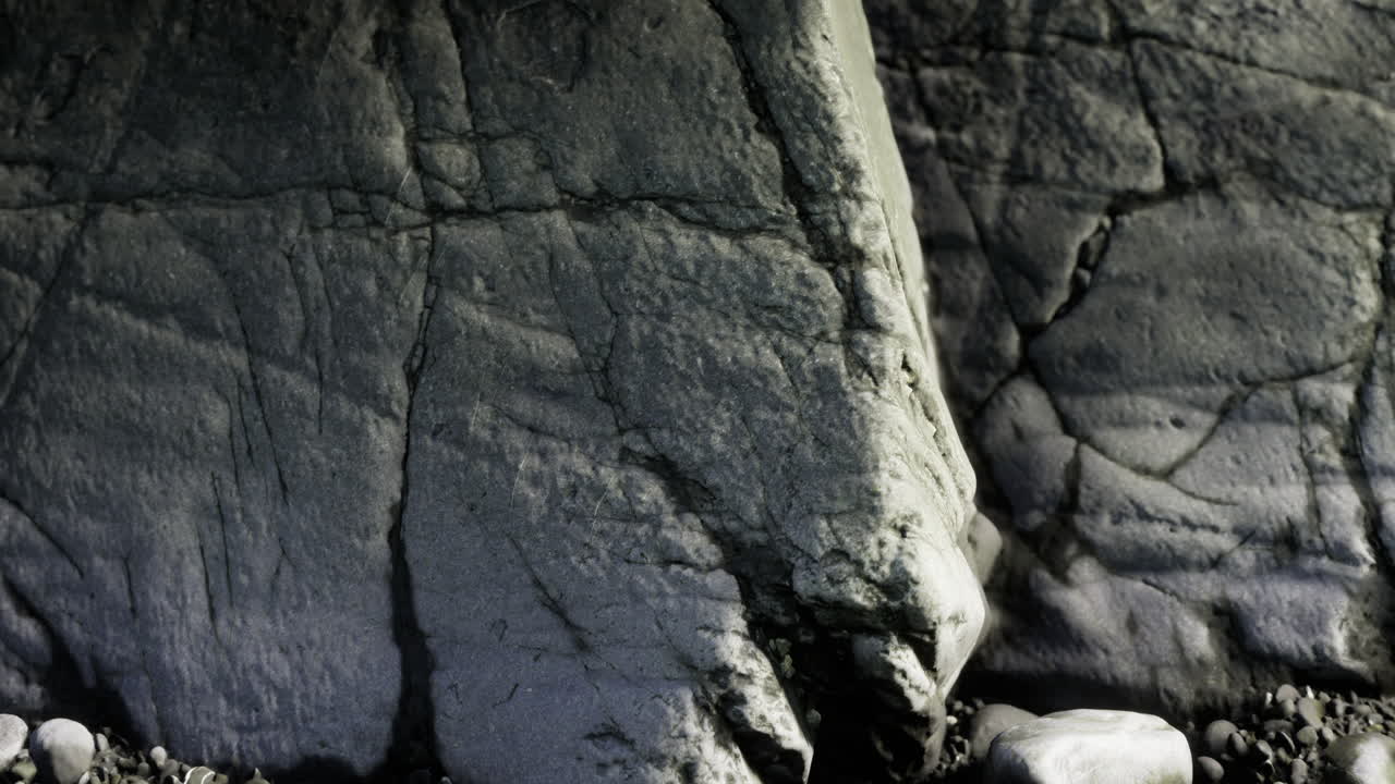 Exploring the intricate textures of ancient rocks along a secluded coastline