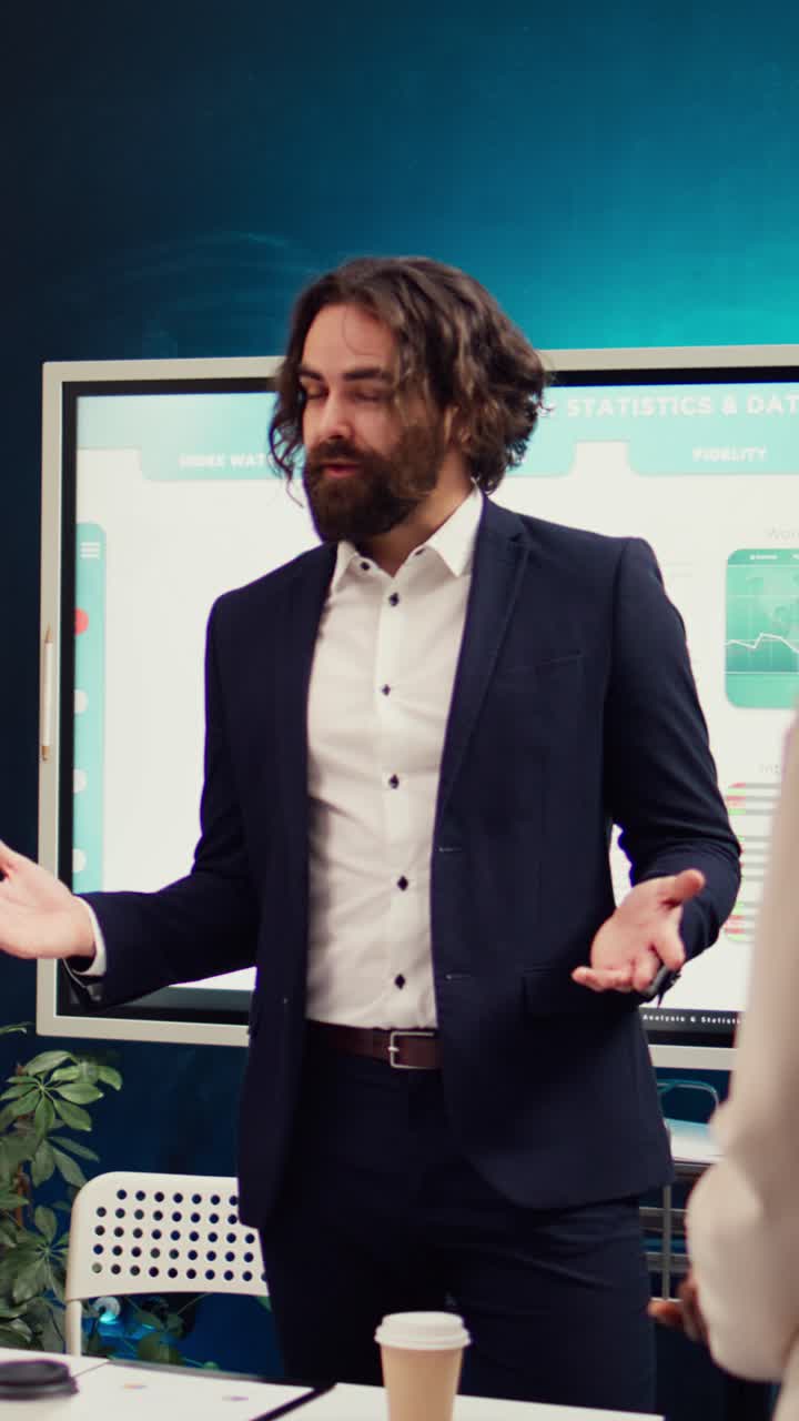 Businessman Presenting Data and Discussing Strategy in Office Meeting