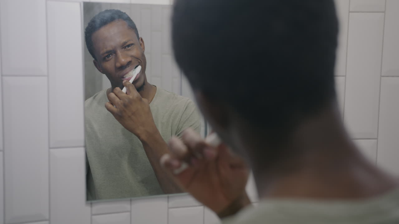Man Brushing Teeth in the Bathroom