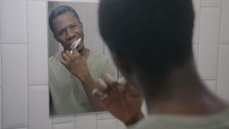 man brushing teeth in the bathroom