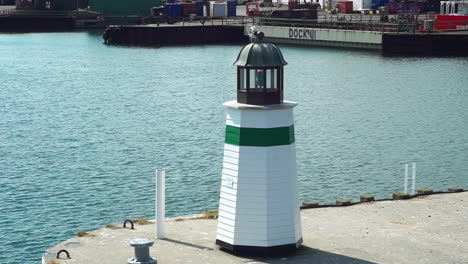 Quaint-lighthouse-on-the-pier-with-calm-sea-backdrop