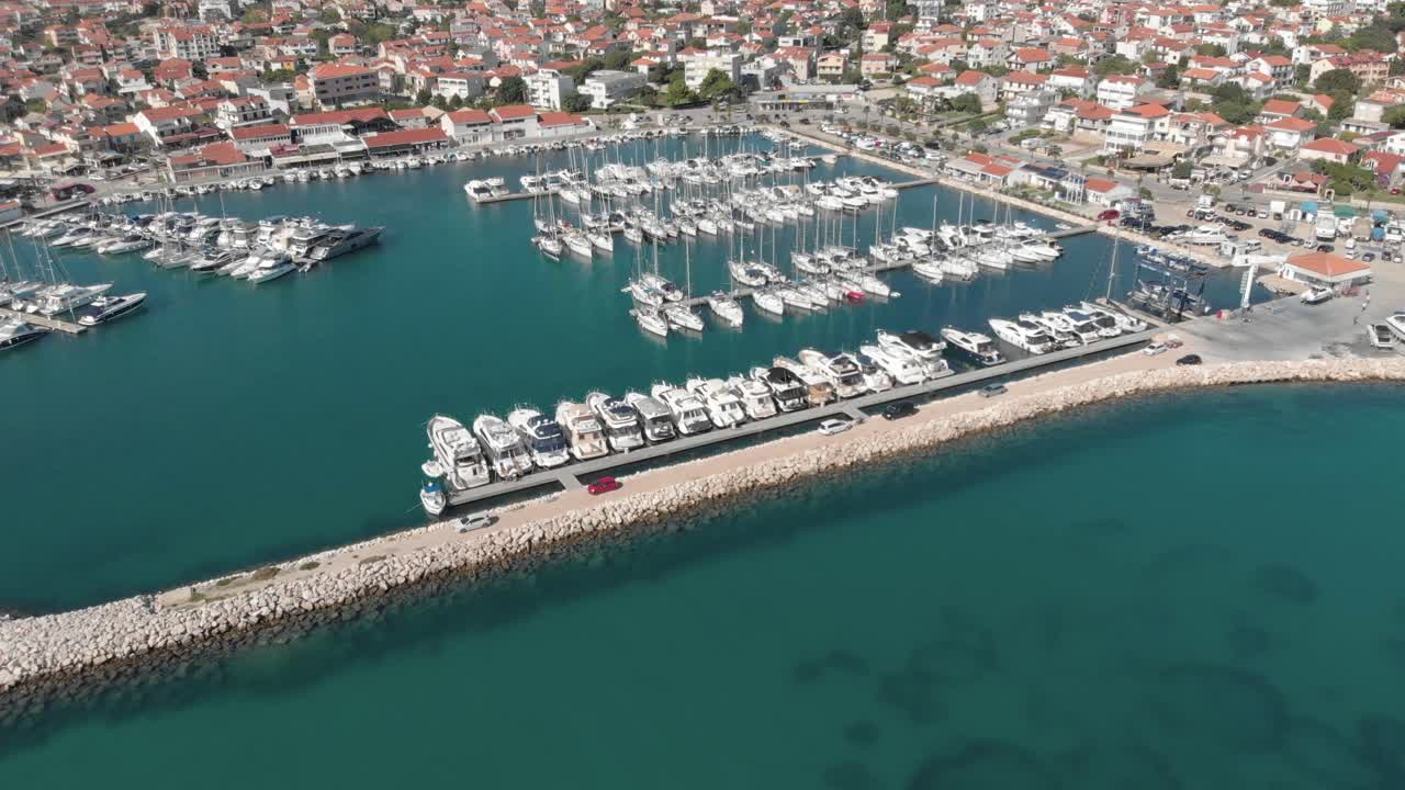 Birds eye view of anchored motorboats, yachts and sailboats at the marina of coastal city at Adriatic sea, Croatia