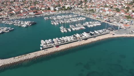 birds eye view of anchored motorboats, yachts and sailboats at the marina of coastal city at adriatic sea, croatia