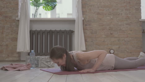 old female stretching and doing yoga poses at home