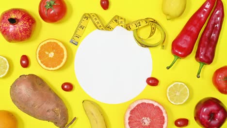 red diet healthy fruits and vegetables move on yellow copy space background. stop motion flat lay