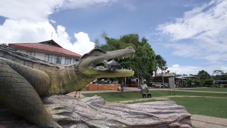 large crocodile statue in a park