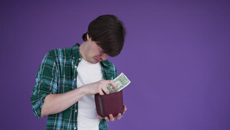 brunet-haired man cries noticing lack of money in wallet