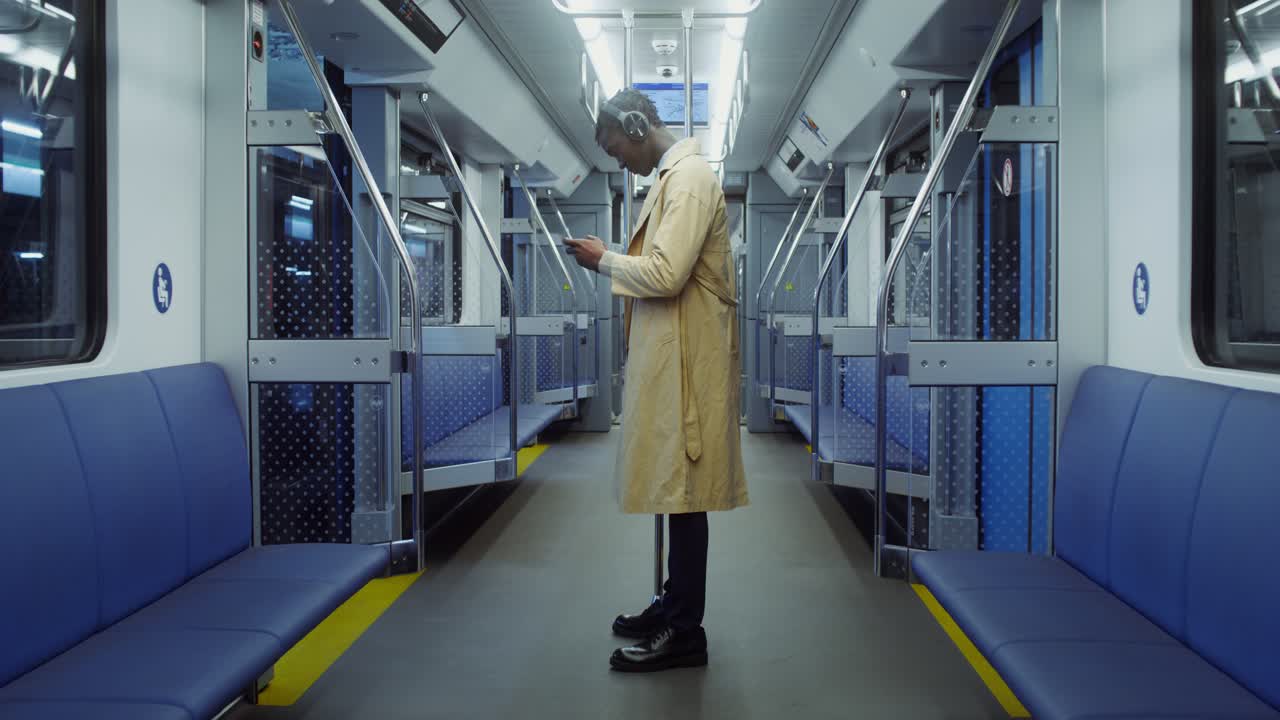 Man Using Phone on Subway Train