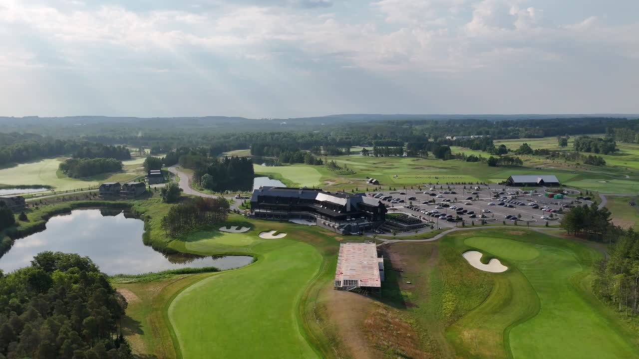 Fairways And Greens Next To Clubhouse At An Professional Golf Course, Pull Back Aerial Shot