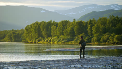 fisherman fishing in arctic boreal summer landscape