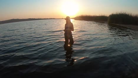 view of beautiful girl fishing with a beautiful sunset in the background in south africa