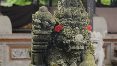 stone statue of hindu god at ubud palace in bali, indonesia, close up parallax