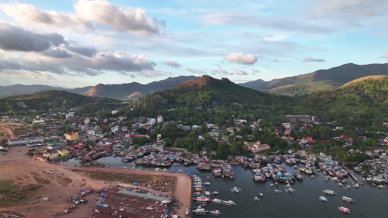 Coron town cityscape, with fishing village on shore, central market building. Philippines.