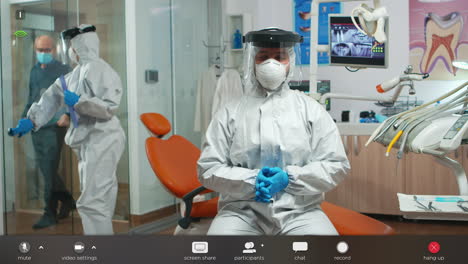 Dentist-with-coverall-looking-at-camera-talking-with-patients