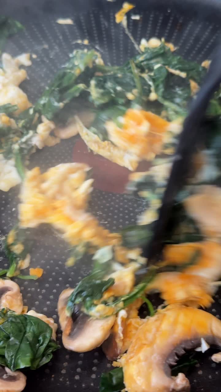 Cooking Scrambled Eggs with Spinach and Mushrooms